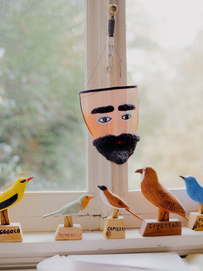 He bought these wooden birds at a market in Italy