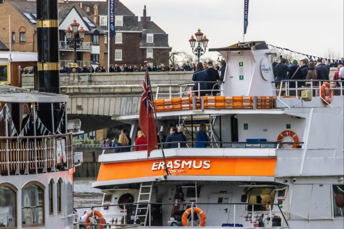 Guests onboard the Erasmus view the 2022 Oxford and Cambridge Boat Race
