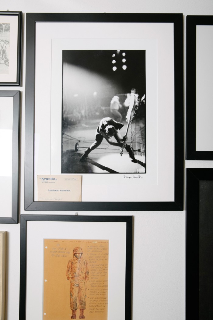 Artwork in his studio including a Pennie Smith portrait of The Clash bassist Paul Simonon and (bottom) concept art for Apocalypse Now