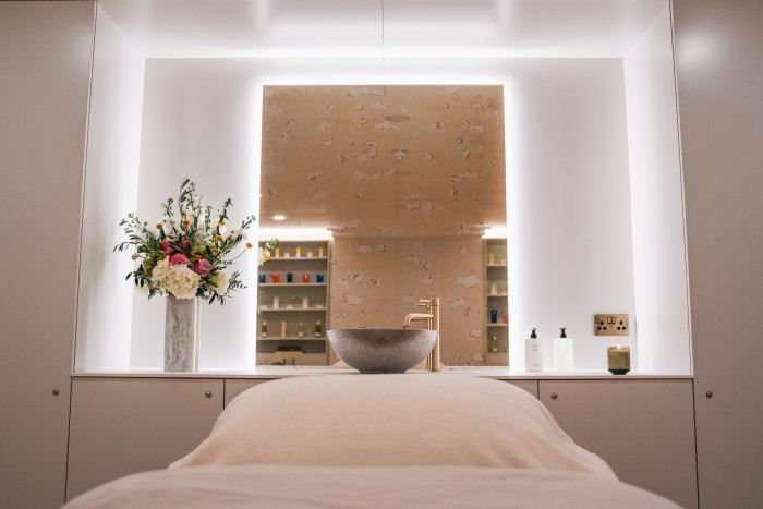 A treatment room in skincare expert Katharine Mackenzie Paterson’s new Mayfair clinic, with a gold tap and metal bowl behind a treatment bed 