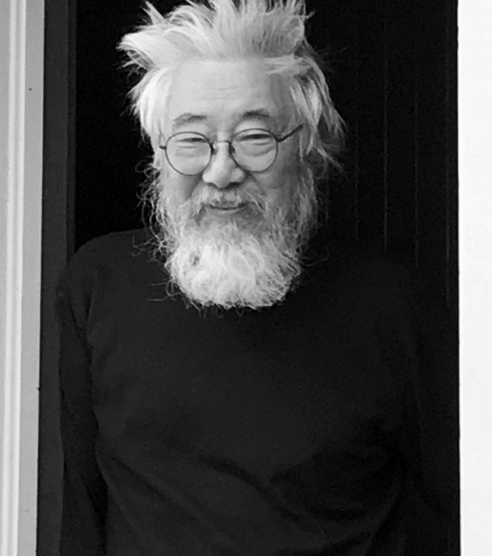 Black and white photo of a man with white hair and beard