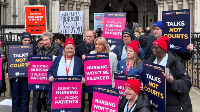 Royal College of Nursing General Secretary Pat Cullen and nurses hold banners as they demonstrate outside the Royal Courts of Justice in London, Britain