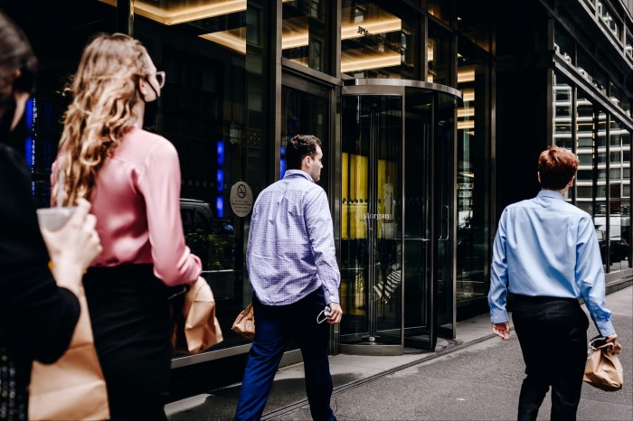 Pedestrians walk by the JP Morgan Chase & Co headquarters in New York