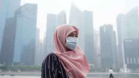 A tourist wears a face mask as haze shrouds buildings in Singapore in September 2019