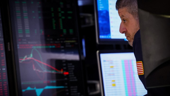 Trader looks at his screen at New York stock exchange