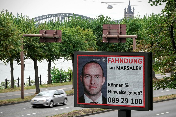 A wanted poster of the police shows member of the management board of German payment provider Wirecard AG Jan Marsalek with a picture showing him on a digital display 