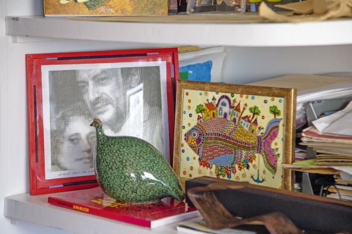 A photograph of Pesce with his late friend Adriana Adams, a ceramic bird and a collage