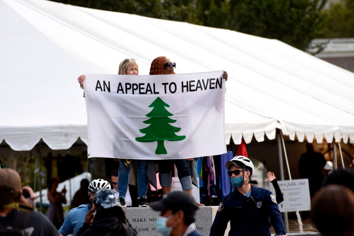 People carrying ‘An Appeal to Heaven’ flag as Trump supporters gathered in Philadelphia weeks before the 2020 election
