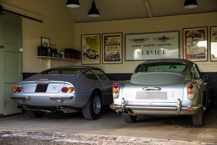 Two of Ephson’s beloved classic cars, from left: a Ferrari Daytona and his 1964 Aston Martin DB5