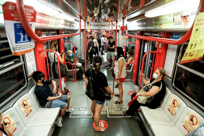 Subway passengers wear face masks in Milan, northern Italy