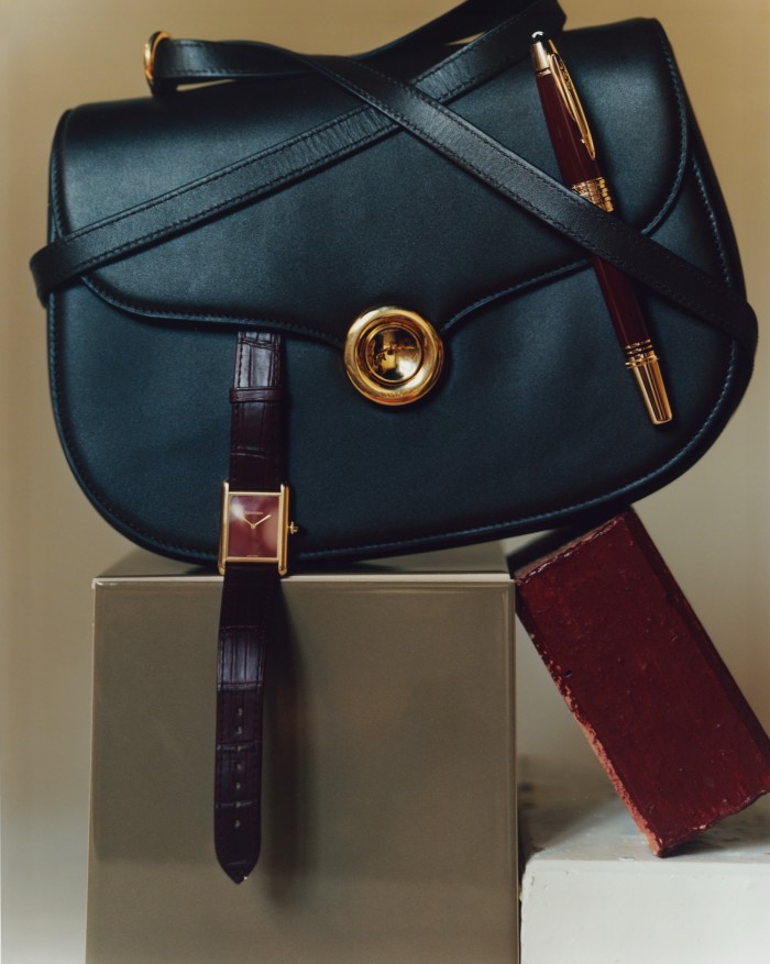 Loro Piana leather Ghiera saddle bag, £3,060. Cartier gold and sapphire cabochon Tank Louis watch with leather strap, £12,500. Montblanc precious resin John F Kennedy Special Edition fountain pen, £955