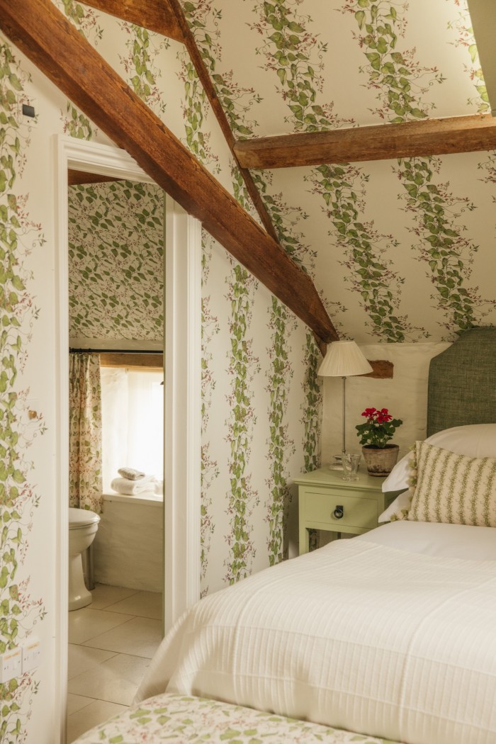 The Gardener’s Cottage at Thyme, decorated with Bertioli Bean Flower Stripe wallpaper and cushions