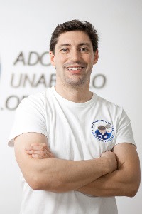 Alberto Cabanes in a white T-shirt smiling