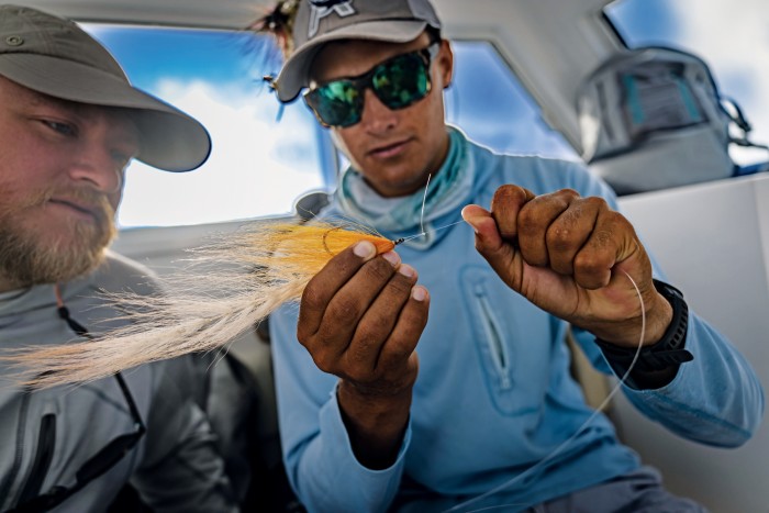 The author and a guide consider what fly might entice a giant trevally