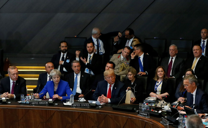 Turkish President Recep Tayyip Erdogan, U.S. President Donald Trump and British Prime Minister Theresa May attend the 2018 NATO Summit