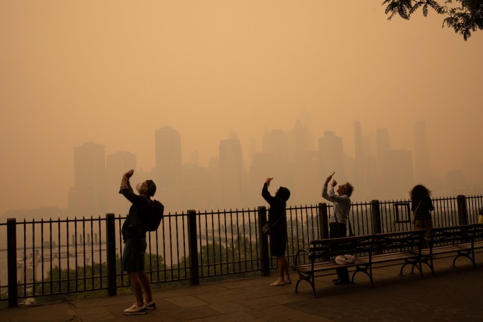 In the middle of the afternoon, smoke from Canadian forest fires blankets the skyline of New York City, June 7, 2023, as seen from Brooklyn, New York