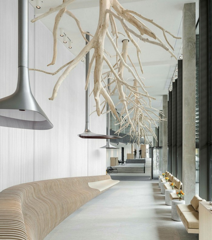 stripped tree roots descend from a ceiling in the Hôtel des Horlogers