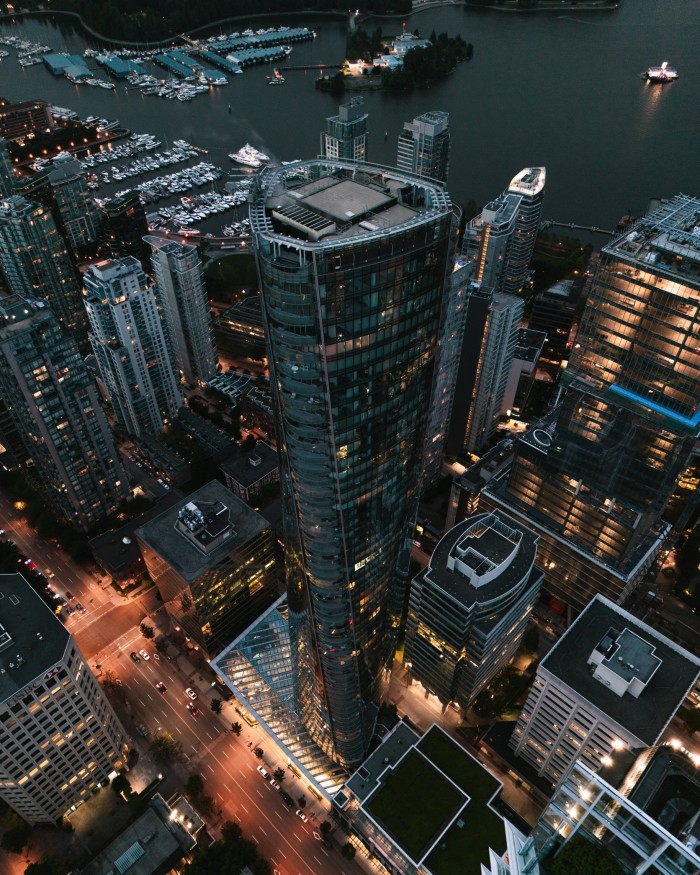 An aerial night-time shot of the 63-storey Paradox Hotel Vancouver