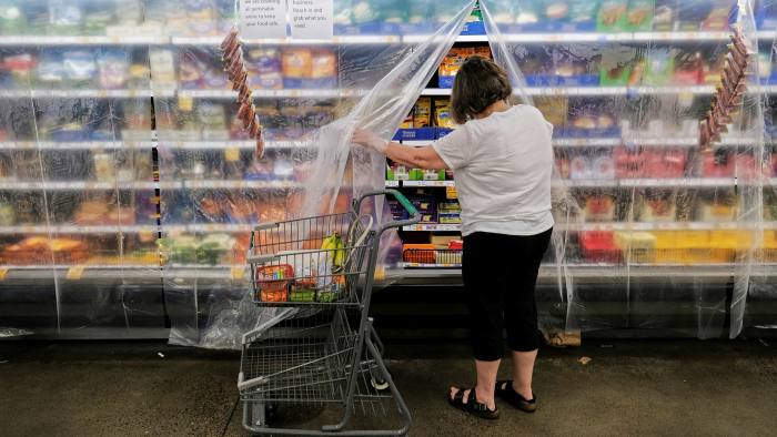 A woman choosing products in a supermarket