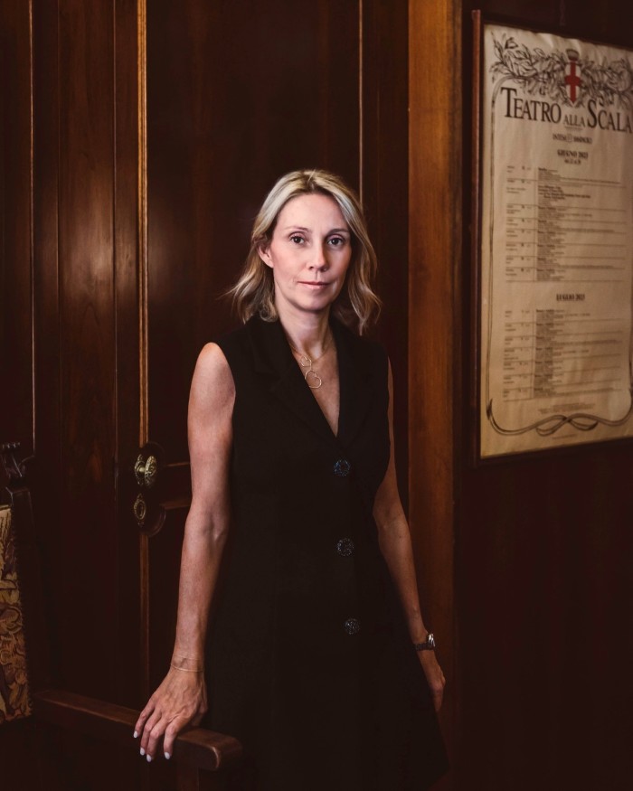 Boeucc owner Monica Brioschi – a slim, middle-aged woman with blonde hair in a black dress – standing against a dark-wood door in the restaurant