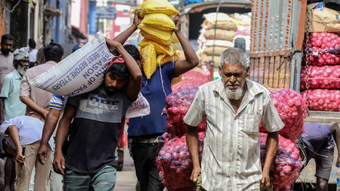 Sri Lankans buying sacks of rice.