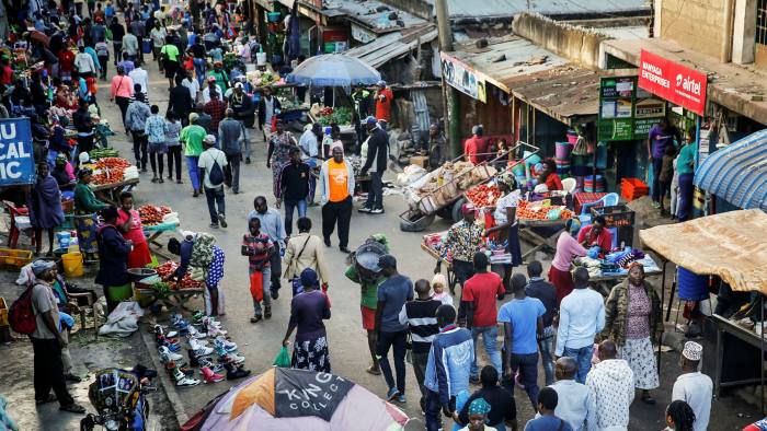 Residents walk through a small and crowded market in the Mathare informal settlement of Nairobi, Kenya