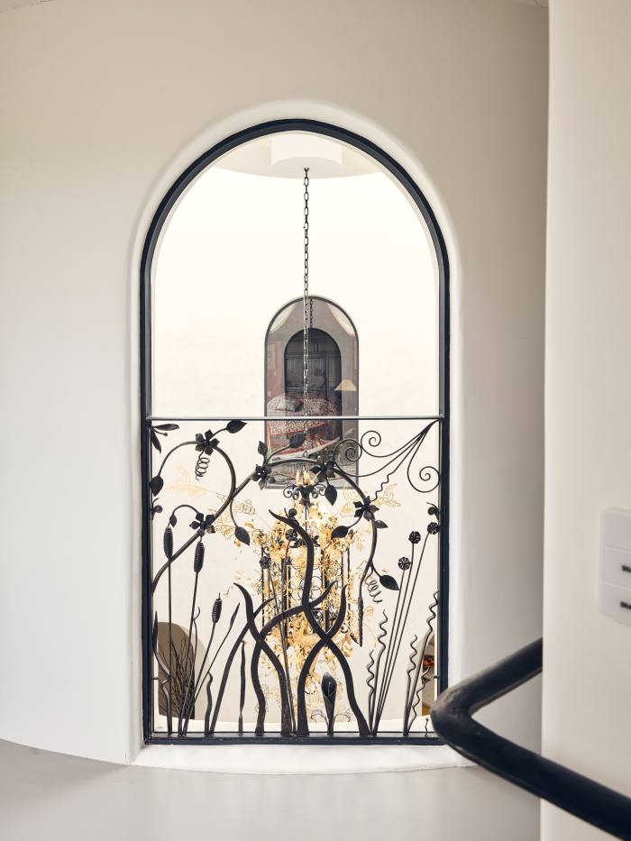 An internal arch with filigree railing looking onto a lantern customised and designed by Leith’s niece