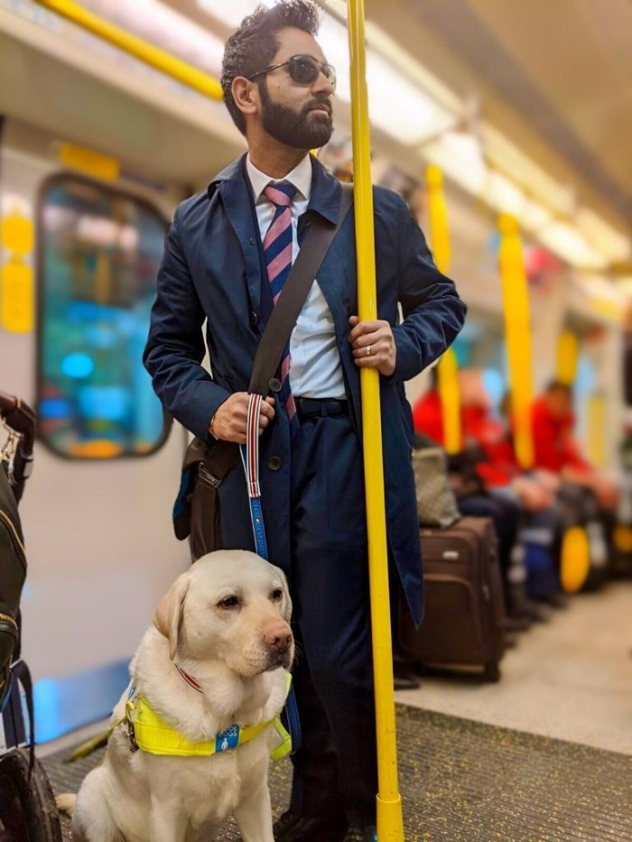 Amit Patel with his guide dog, Kika, on London’s Underground public transport