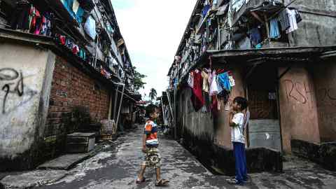 Children in a slum area in Palembang, Indonesia, where poverty has increased because of Covid-19
