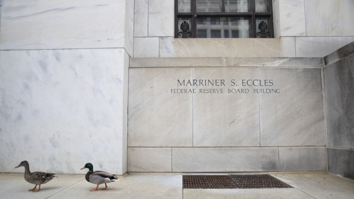 Two ducks waddle past the Federal Reserve building in Washington DC