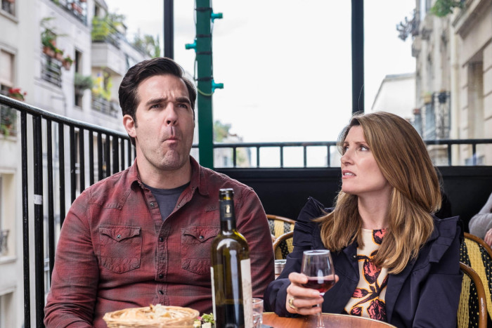 Rob Delaney and Sharon Horgan sit together at a bar in the series ‘Catastrophe’ 