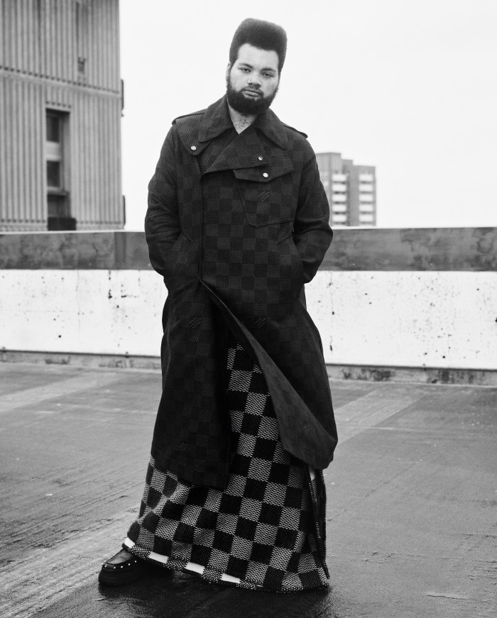 Bartender Bear Cox, 20, wears Louis Vuitton denim jacquard coat, £5,550, and wool/cashmere blanket (worn as skirt), £970. Leather shoes, Bear’s own
