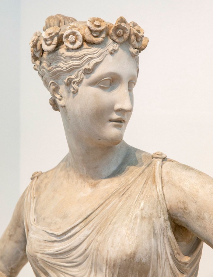 Marble sculpture of a woman with flowers in her hair