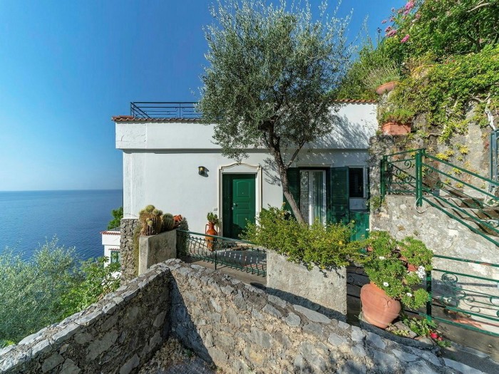 cliffside white villa, terrace and vegetation