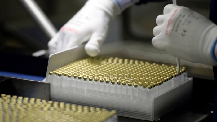 An employee checks insulin vials at a pharmaceutical factory