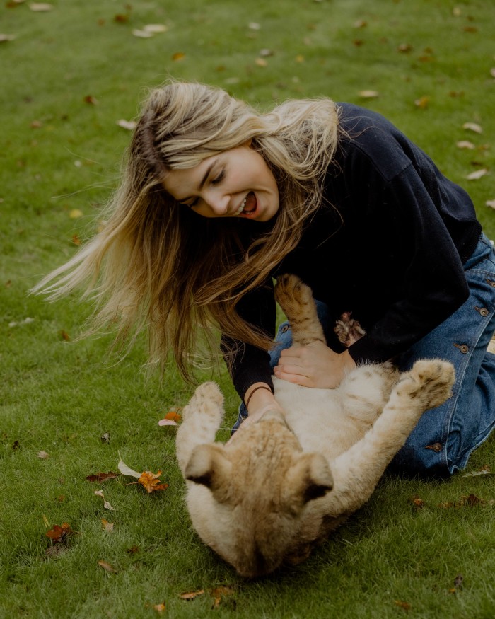 Freya plays with Zala the lion cub
