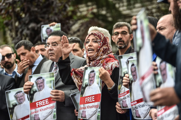 Protesters hold posters of Jamal Khashoggi