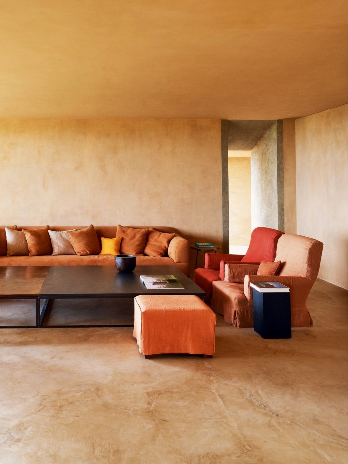 A new house in Ibiza designed by architect Tatsuro Miki with interiors by Vervoordt, whose workshop made the walnut and slate coffee table – the textiles are by his wife, Ma