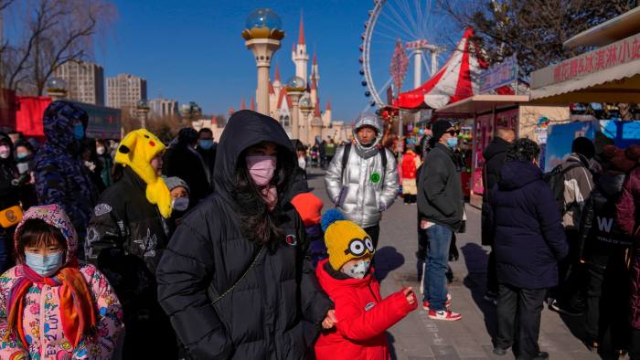 People queue for confectionery at the  Shijingshan amusement park in Beijing