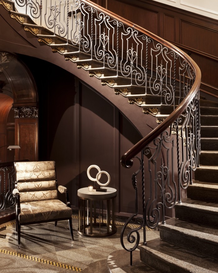 A dark-wood staircase at Rosewood Hotel Georgia, Vancouver