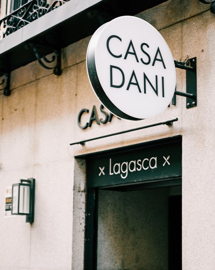 The façade of Casa Dani, with its circular sign above the door