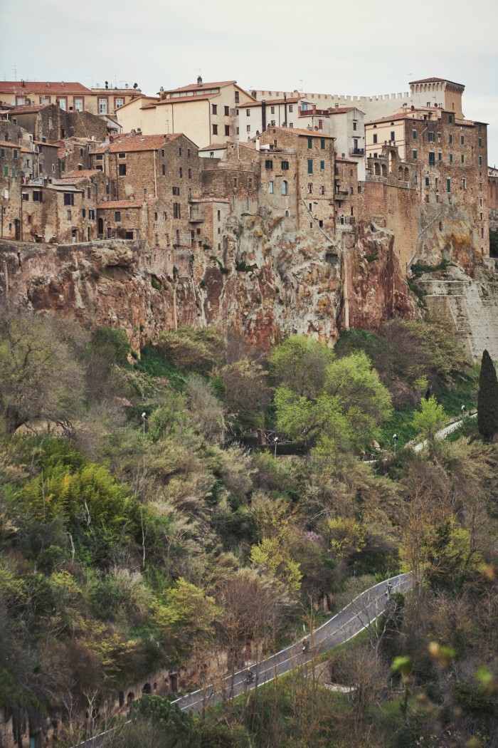 The riders at the foot of old-town Pitigliano