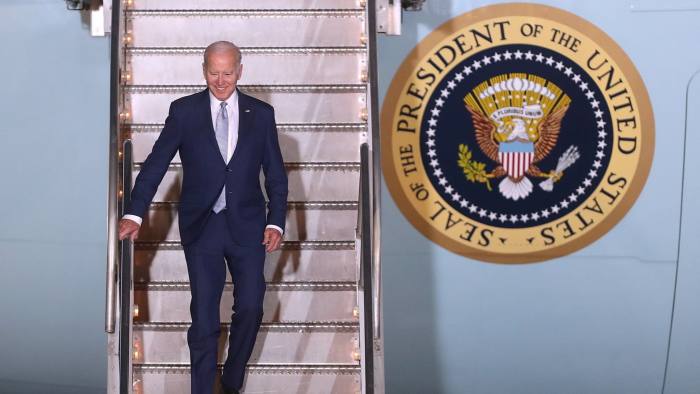 US president Joe Biden descends the steps of an aircraft