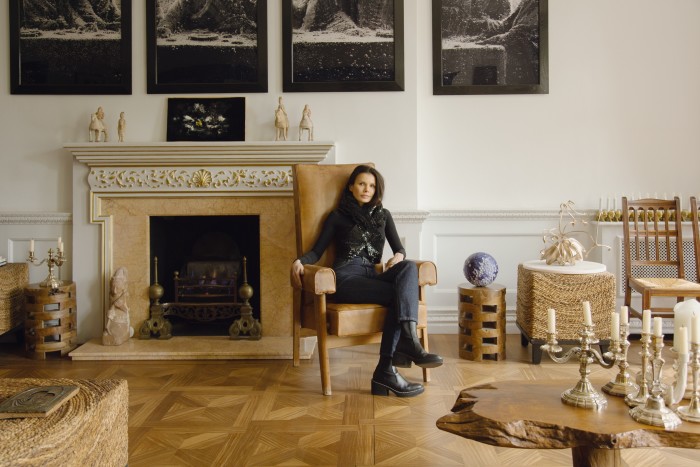 Nguyen-Ban in her Alaïa leather sequinned top and jeans; on the wall behind her are Immersions, Black Supper I-V, 1990, a series of works by Andres Serrano, and (on fireplace) Untitled, 2018, by Oscar Murillo