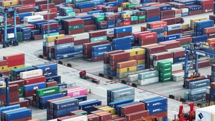 A truck drives between containers at Nanjing port in China’s eastern Jiangsu province