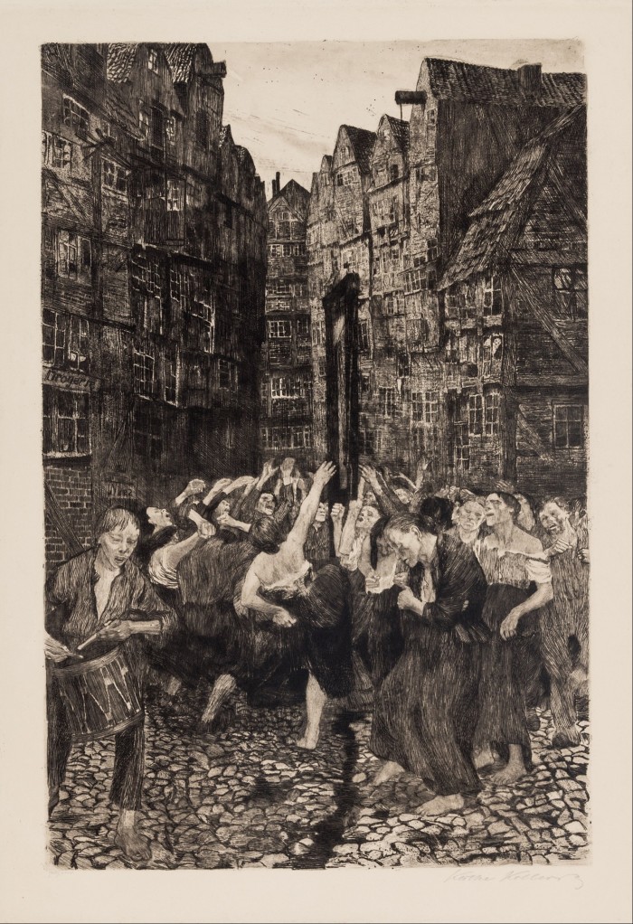 In a black-and-white print, men and women dance around a guillotine in the cobblestone streets of a medieval city.