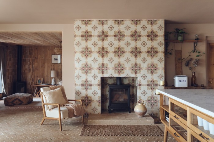 Salvaged tiles on the kitchen chimney breast and Raw Thick Bejmat floor tiles. The vessel on the hearth is from Vinterior