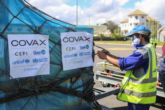 A worker handles boxes of vaccines for the Covax programme in Madagascar