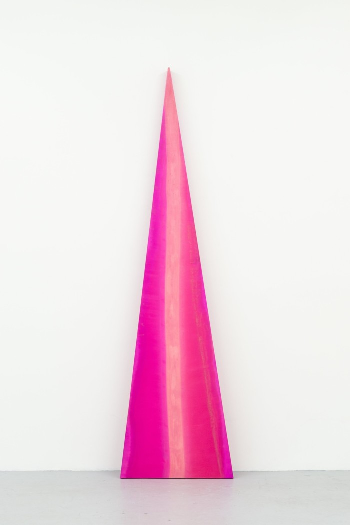 A tall pink triangular sculpture