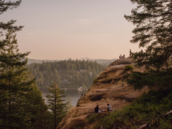 The view from Quarry Rock Lookout, across a lake and forest towards Vancouver’s skyline